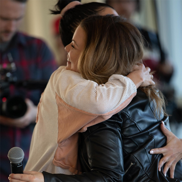 Spirit Medium Tiffany Rice hugging an attendee at a group reading.